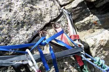 Here's a pic of anchors on top of Sharkstooth. Three old pins backed up with a chockstone. The rap station is on N.E. side of the summit.
