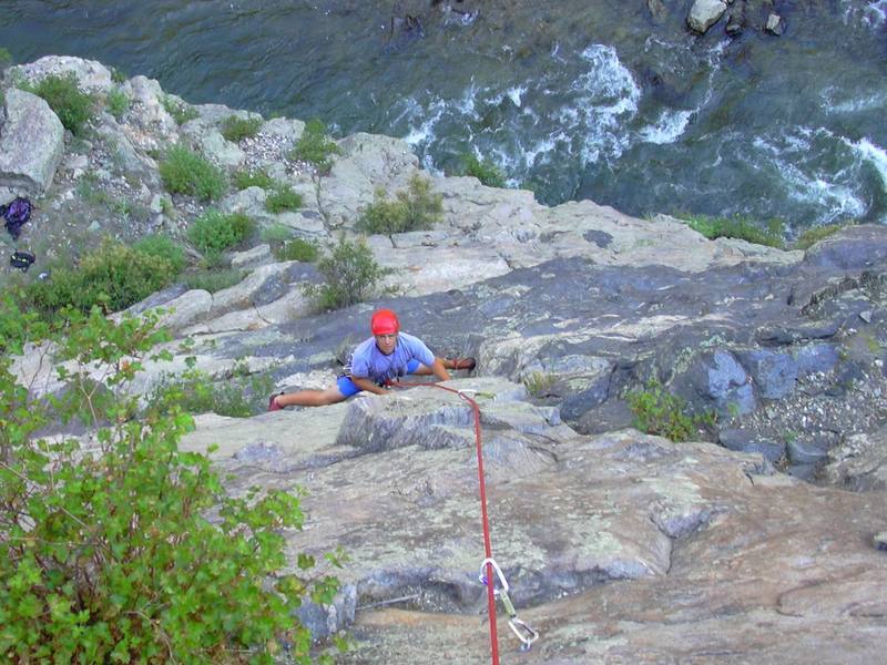 Hill stemming the crux of pitch 1.