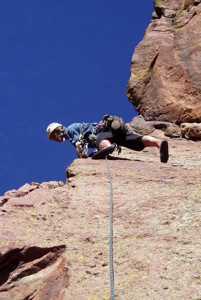 At the bolt on the slab on pitch 2. Looking down at Jules Verne.<br>
Photo by Paul Rezucha.