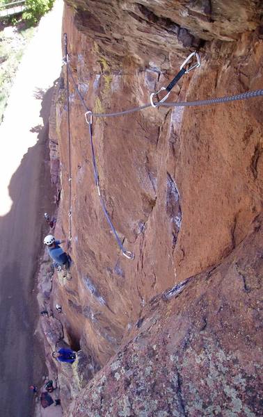 Looking down the crux pitch on a typical busy Bastille day. The chalk everywhere indicates the various options. I climbed the crack to the high pin, then down right to the bolt (with the two long slings), then back up to the belay.