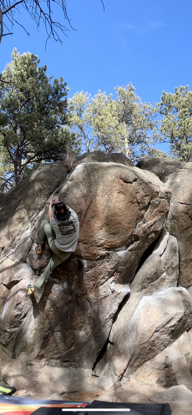 Hanging onto the slopers before the big move to the top!  I have only seen people using the cracks up high and going left vs. staying on the arete, anybody know what the intended line is?