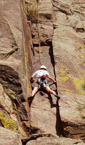 Janet Conner stemming the crux slot on the first pitch.