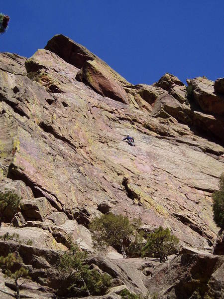 An unknown climber in the middle of the 5.7 "slab" first pitch of Allosaur. I say slab in quotes, because the first half of this is quite steep. The route continues to the slanting overhang above, left around that (8 or 9) into the left facing, right leaning corner. Most people belay here, combining pitches 1 and 2. Out left below the final overhang with the crux being the last move pulling around onto a low angle slab.