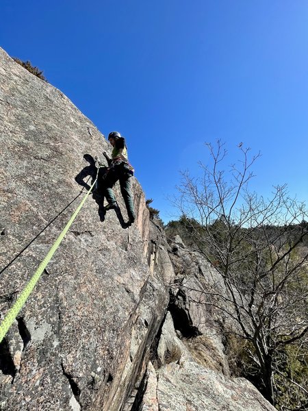 This shows the crux of the second pitch. You step off the belay ledge, and can immediately clip the first bolt. The 2nd and 3rd bolts are within 5 feet of each other. Just a couple little crimps, and then a mantle and you are onto mellow terrain to anchor