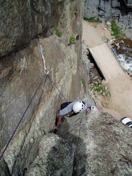 Chuck just about done struggling with the finish to P3. As with P2, the crux is not the overhanging layback, but getting established on the lower angle rock above. The piece above Chuck is a good green Alien. A good idea to keep the rope from running over the top cams if the second should fall. Shortest approach in Boulder! That's our car below. Just like the old days when you could park at the base of the Bastille.