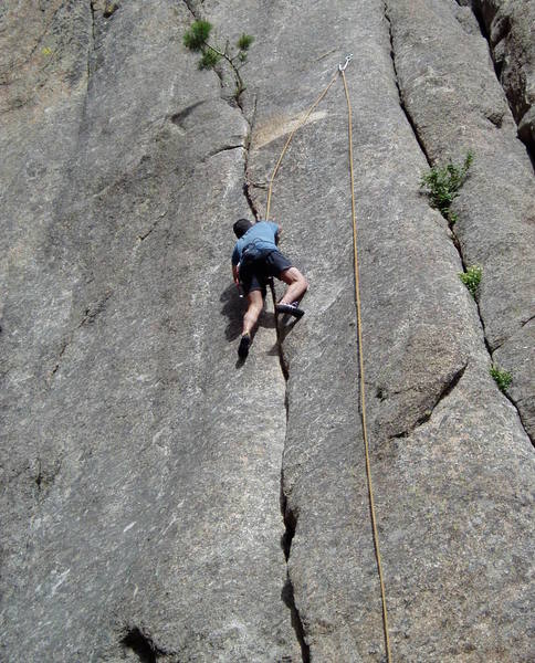 On the alleged crux which felt several letter grades easier than the crack below. This section felt pretty thin to me, with the hardest move being the last move to reach a good hold above the directional, but Chuck made it looks like there were big footholds everywhere. You can easily top rope this off new bolt anchors by leading either Road Kill 10b or Sports Pages 5.8.