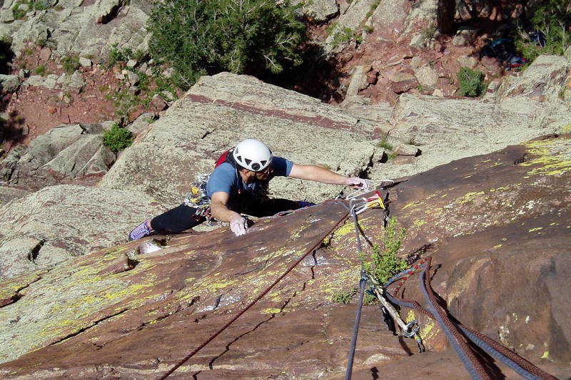Above the roof on P2. You can get a rest via a precarious stem or by moving further right. Notice the sling Chuck is removing. It's on a razor sharp very thin flake. It might hold body weight. The first pitch of Old Farts is straight down from Chuck's left hand.