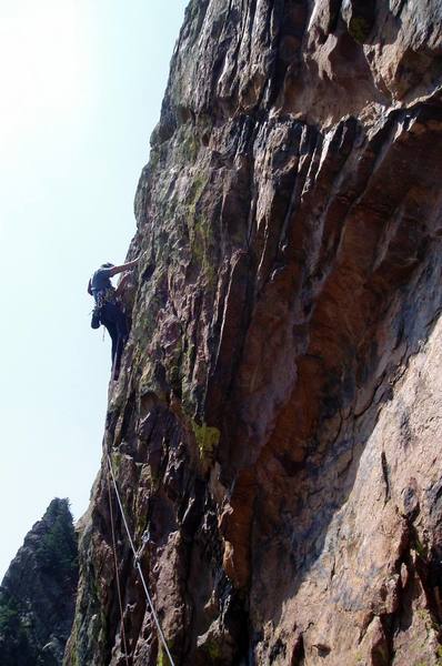 At the second bolt and the 10a crux. Move up and left to the arete on strenuous but positive slanting finger holds with mediocre feet.