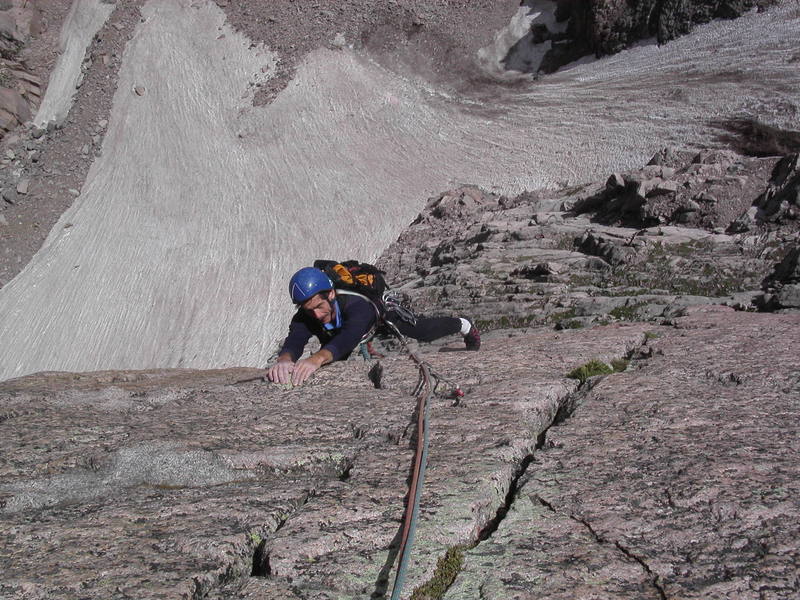 Mike Amato nearing the top of the second pitch, with Lambs Slide and Mills Glacier below.