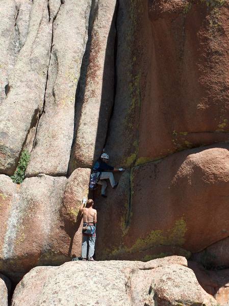 Me getting started in the bouldery crux section. The crack above was pretty continuous. The only way to rest was with your feet crammed in the crack. Photo by Chad Stebbins.