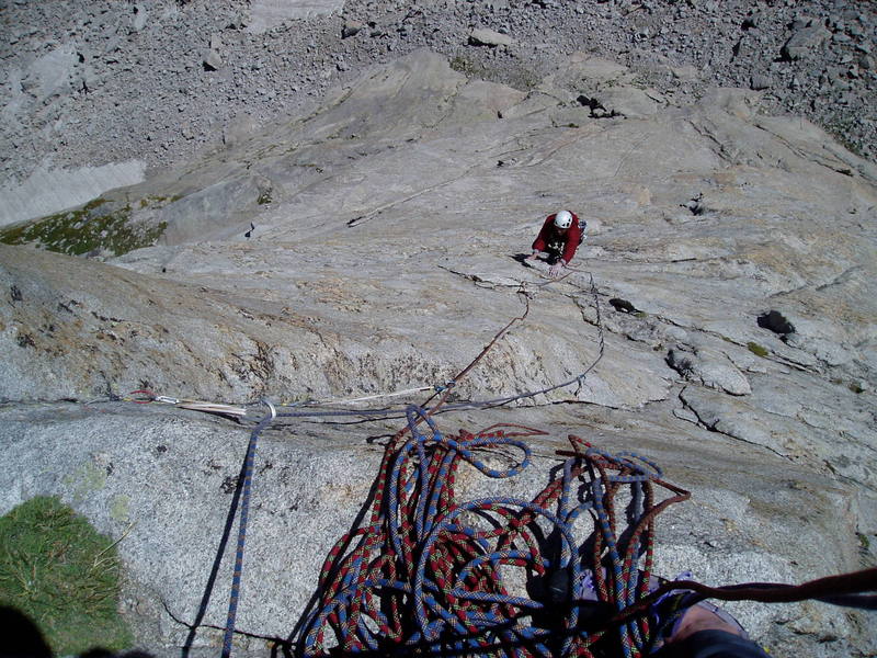 Looking down from the top of P3. Chuck has just traversed left past the second bolt. To Chuck's right (left on the photo) you can see the final cracks and flakes before the traverse. 