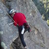 Marga Powell cranking the crux on the second pitch.  She's working to get her left foot stemmed on the lip of the roof.