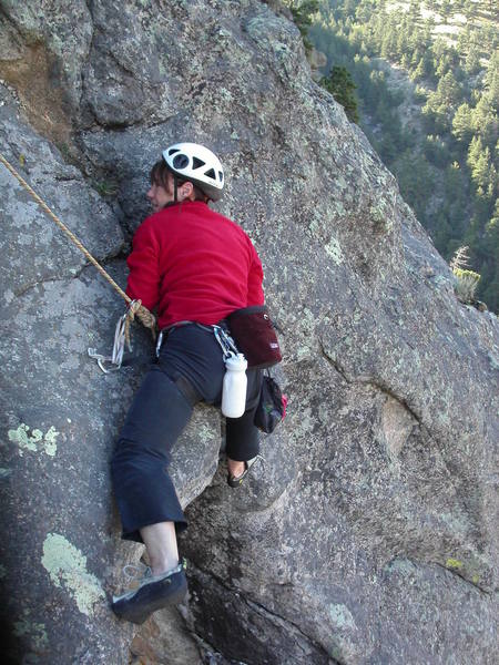 Marga Powell, almost through the crux on the second pitch.  She has the left-foot stem...