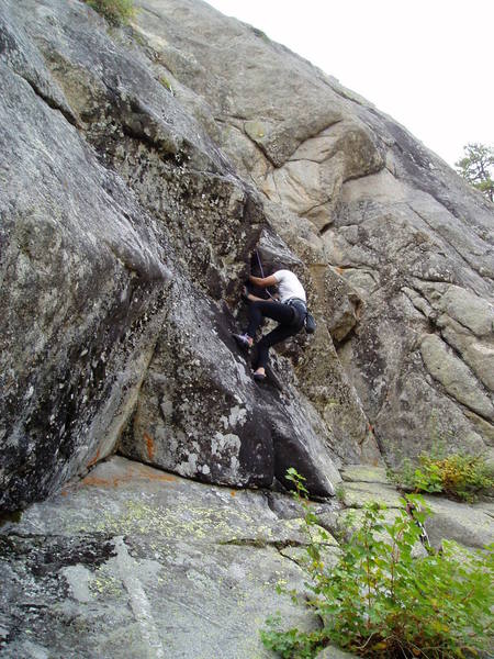 Chuck with the initial hand jams in the roof. Black Rain climbs through the top left of the photo. Prince Charmer it the left facing corner right of Chuck. Aerial Boundaries climbs the ceiling diagonally up and right from Chuck in the photo.
