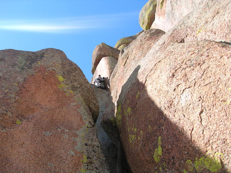 Me on the upper "hand crack" section of the climb, after exiting the offwidth section. One more wide section still remains above me. I did the entire climb as one pitch.