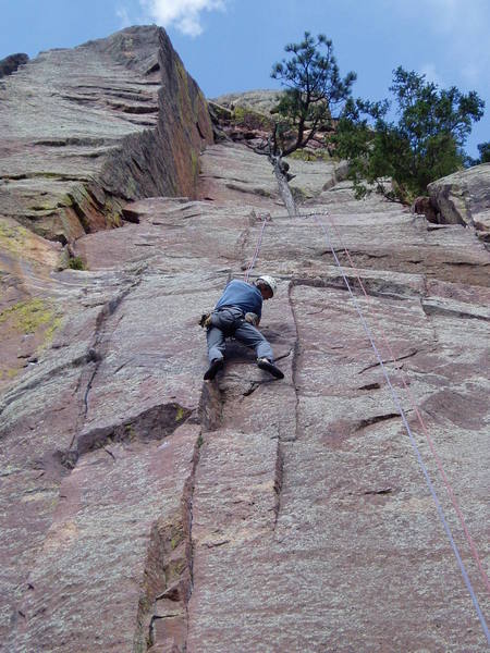 Starting the crux sequence. There are some decent sloper footholds above my right foot and some small edges that you can toe on in the corner. If you're tall enough (I am, barely) you can extend off of these using a fingertip layback and reach a jug at the top of the corner.<br>
<br>
Photo by Paul Rezucha.
