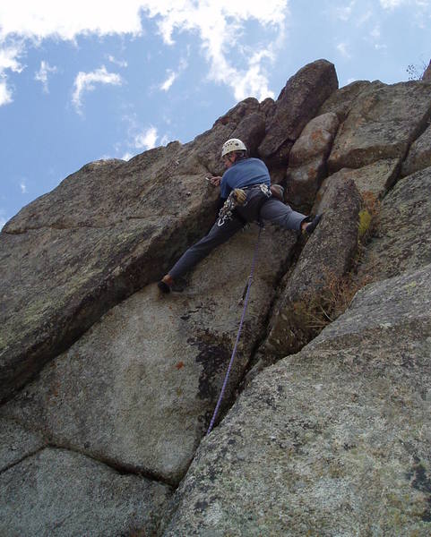 At the P4 crux roof at the very top of the crag. This pitch is contrived but fun. If you're tall enough, it's a stretch for a big hold, and you're done.<br>
<br>
Photo by Paul Rezucha.