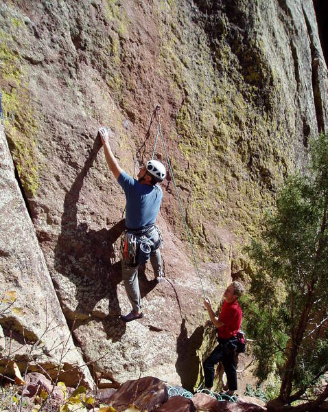 Starting the crux sequence. Thin feet lead to a good hold above Chuck's left hand. More thin feet but good hands lead to a good stance to clip the second bolt which is above the top of the photo.<br>
Like Clarke is belaying.