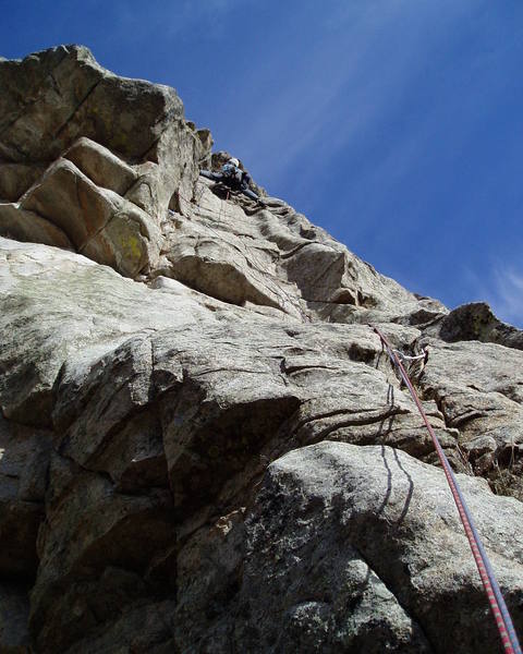 At the top of the P2 crux. I ended up at the top of the rounded left-facing corner and had to stem back left. The lower of the two P2 belay stances is just to my left.<br>
<br>
Photo by Chuck Graves.
