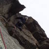 On the 3rd and last pitch. This pitch is 8 or easy 9. It's way runout above the ceiling at the skyline above Chuck with the difficulty depending on how directly you climb. Maybe 5.6 or 7 if you climb straight up. Fun on TR.<br>
<br>
The old bolt is in the groove at the bottom left of the photo. Chuck chose to climb the natural line directly above the belay and right of the bolt, but should you choose to climb directly at the bolt, there is some gear, and the moves at the bolt are not particularly hard.