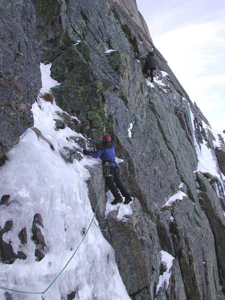 Christa has just crossed manky ice and is approaching the difficult move onto rock ledge about ten feet above her.