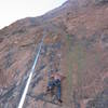 The line.  The climber is moving out of the crux sequence - hard crimp to left-hand gaston - near the third pin.