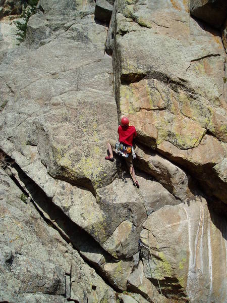 Finishing the crux section. Hand traverse right, stand, and jam back left to get to this point. Eldo of the People, 12a, climbs the ceilings at the far right of the photo to the slab above.