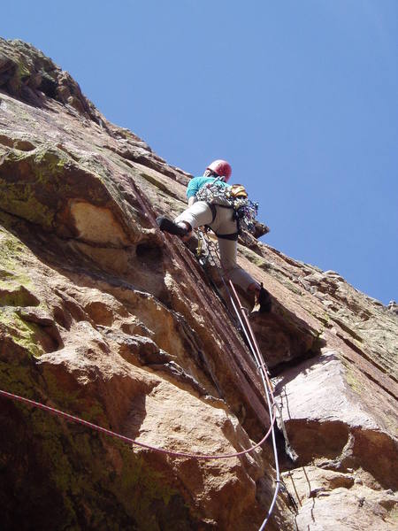 Pulling over the hang onto the runout 5.8 face.