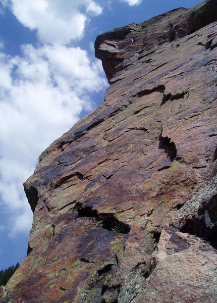 The third pitch from below the Super Slab belay. The route traverses straight left to near the arete. Then up the face and, in places, the arete, to the overhanging headwall. It then diagonals right on positive 5.9 or so climbing to meet up with Super Slab near the top.