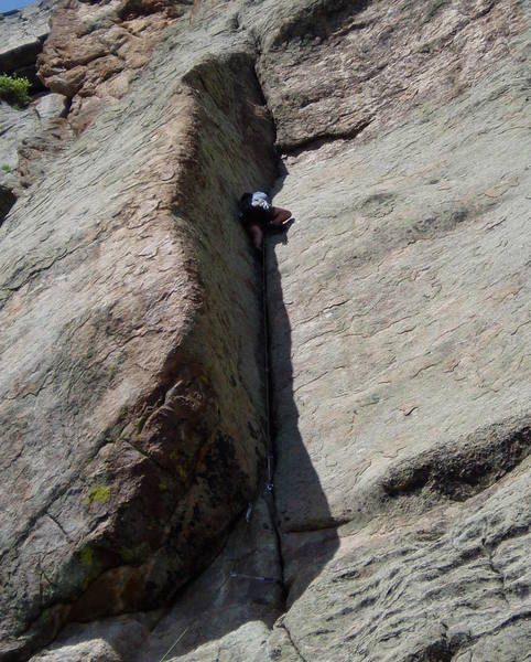 Chuck on the "easy" section. The angle eases off here, but the hand jams still suck. It gets hard again about 10' higher. You stemp a couple o moves up the overhanging crack then escape left around the arete.