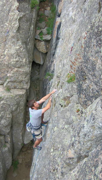 Climber on the sustained crux section of Dead Again.