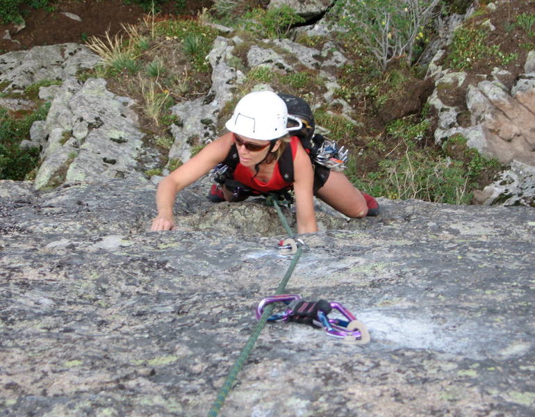 Nickie Kelly at the horizontal crack on the steep upper face. The hardest moves are above her at the last two bolts.