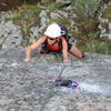 Nickie Kelly at the horizontal crack on the steep upper face.  The hardest moves are above her at the last two bolts.