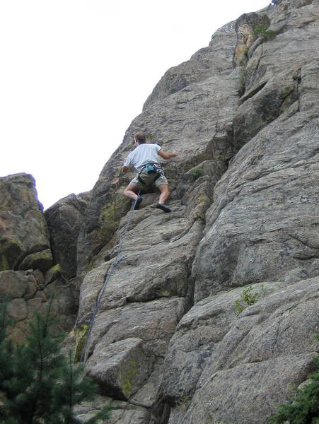 Climber contemplating the crux of Christal Ball.