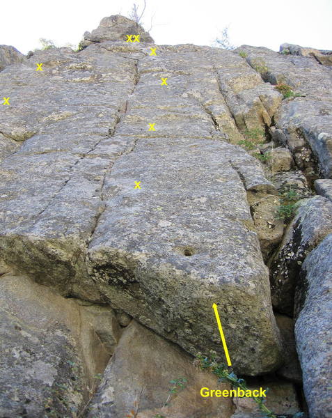 Greenback. Climb past a neat hole, then work up the continuously difficult face using the crack and seam to the left.<br>
<br>
A sustained and intricate pitch.