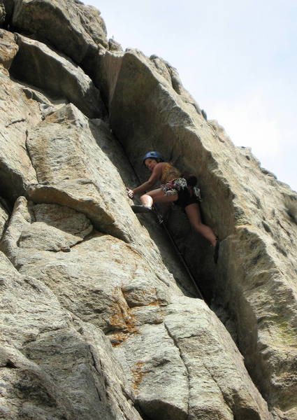 Marga Powell at the crux. Small cams provide good protection for the insecure moves to the top of the corner.