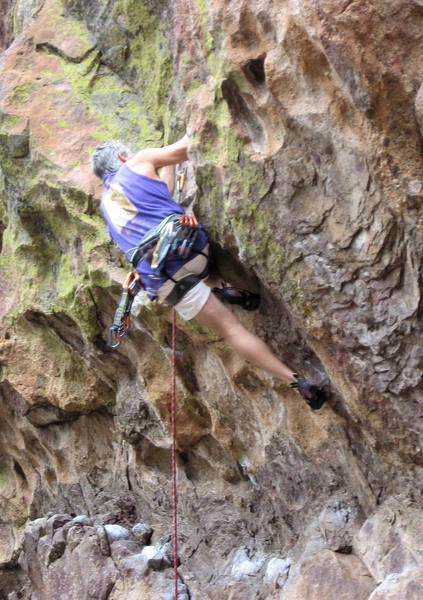 Chris making a key right foot placement on a scoop below the roof.