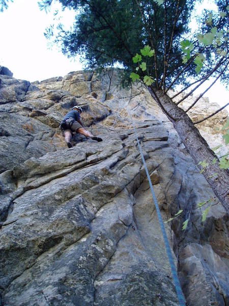 There's a moderate slab move here and a finger jam move higher to get to the ledge. You may be ablee to see the long slings on the anchor--the bolts are far apart. The anchor really needs to be fixed. Perhaps it was set up this way to minimize the swings when toproping Merry Men, on thte left, and Robbin' the Hood, on the right.