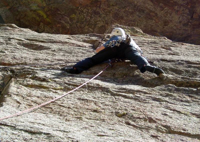 Placing several marginal piecesa the bottom of the right crack. There's not much for the hands, but the feet are good. My left foot is on a slanting ramp. You can step up onto this ramp above the left crack and then carefully move right, but on the lead you probably want to stay low, stem to where my right foot is, and then bring your left foot up.<br>
<br>
Photo by Luke Clarke.