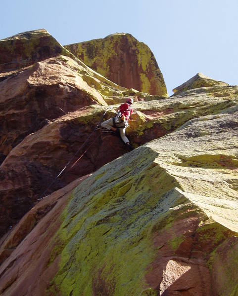 Starting the moves through the roof. Jugs lead to a finger crack. An inobvious move makes it pretty easy. You have to do some work to get the gear. The first gear in the roof is mediocre, but enough to protect you as you pull up on the jugs to get the good gear. Make sure to protect the second after you gain the ledge, since you have to hike right and up a gully to the next gear.