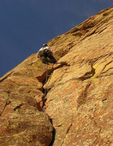 Mike leading the beautiful curving corner on our third pitch. Mike will continue up to the roof and turn it on the left. <br>
<br>
Above, he will climb straight up to an airy ramp, follow it left and up, then continue straight up past a prominent chicken head to the top.