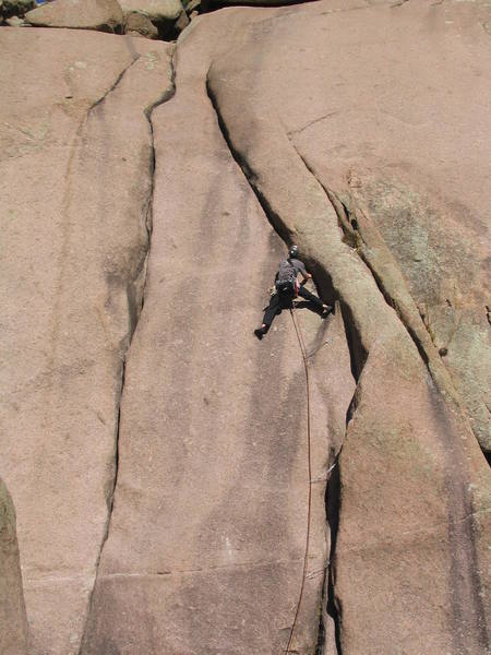 Just above the crux 8+ moves at the bolt. Stemming through this section eases the dificulties.