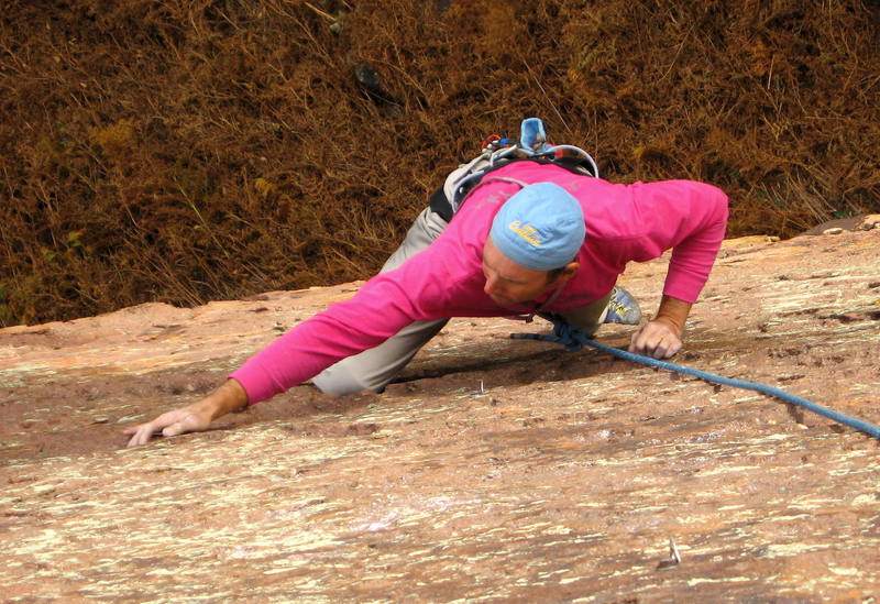 Bruce cranking the thin moves past the next-to-last bolt.