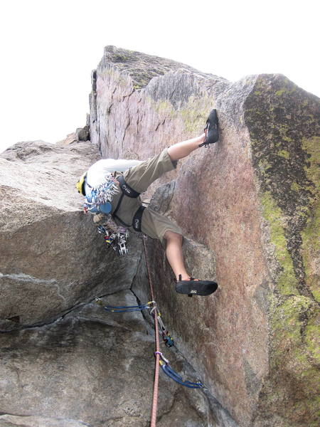Brenda starting the crux sequence. Her right foot is on the only good foothold.<br>
She has to get her left foot over the lip of the roof, even with the current position of her left hip.