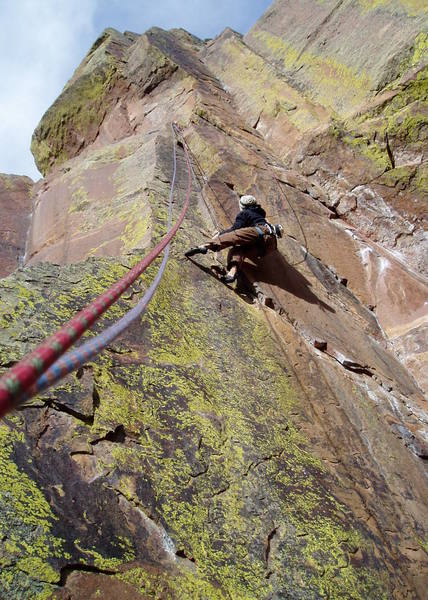 Pulling into the shallow corner on P1 of False Prophet. False Prophet steps right to this point from the slab on the left. The top of P1 dihedral of Practice Climb 101/Practice Wall can be seen at the far left. The P2 dihedral of Sidewall/Practice Wall is directly above Adrien. 
