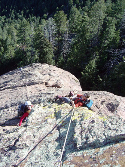Kristin and Peter hang out at the belay ledge atop the second pitch. You can see Fabio beginning the second pitch far below.