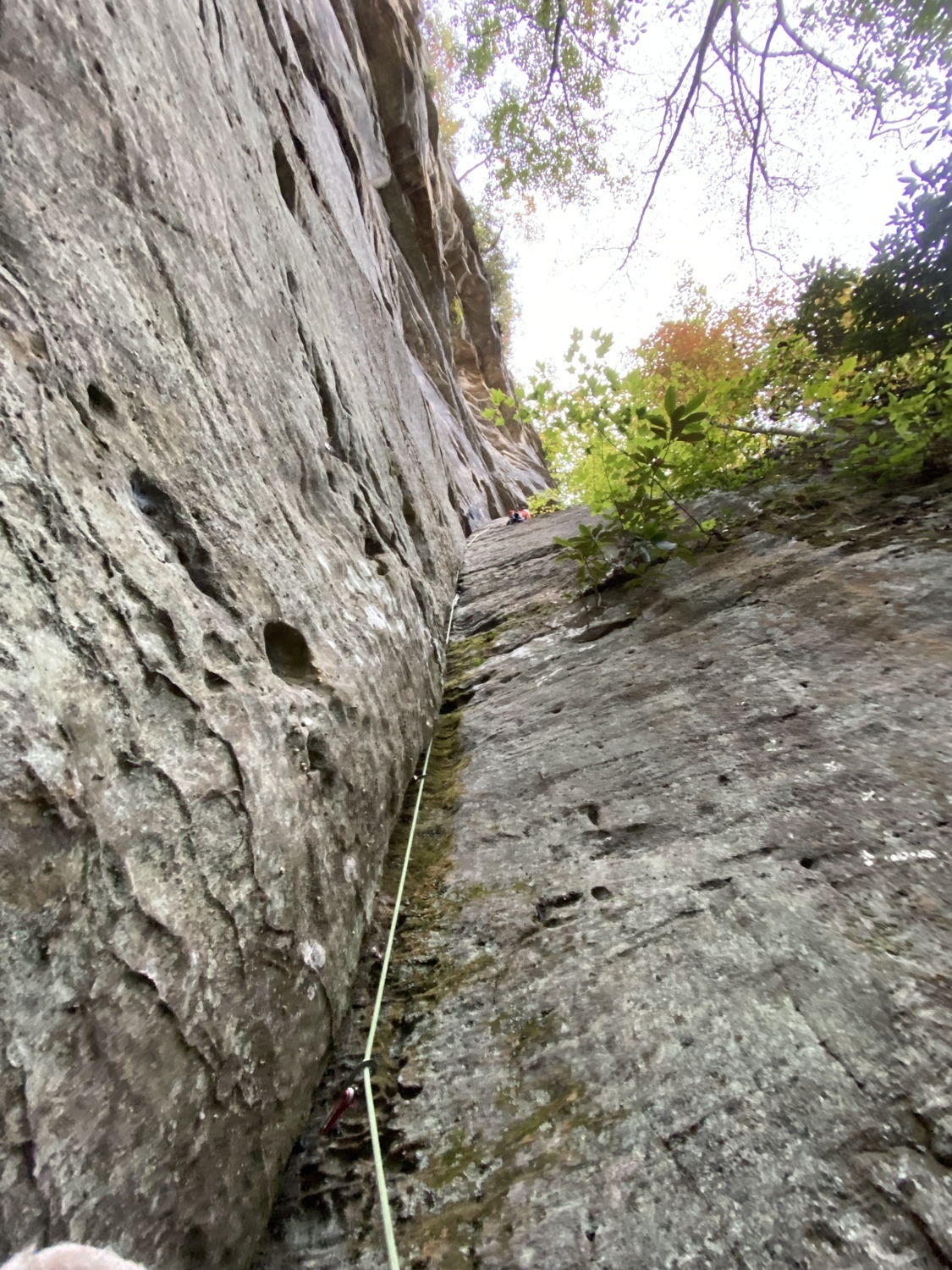 Climb the dihedral crack all the way up to a ledge where a small