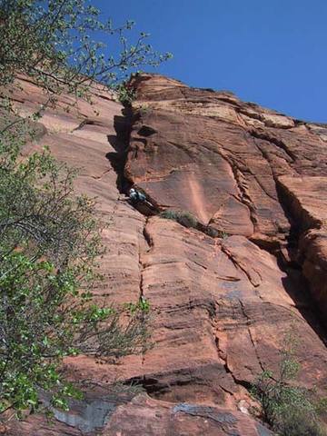 Pitch 4, which leads to the main upper dihedral system. Route traverses into crack from the left, Greg is following and nearly at the belay.