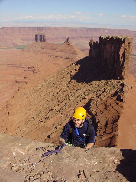 Anders, the Euro Sportclimber, still smiling with 400ft of air below his feet. N Face rap off Casleton with parties on the Rectory's Fine Jade in the background.