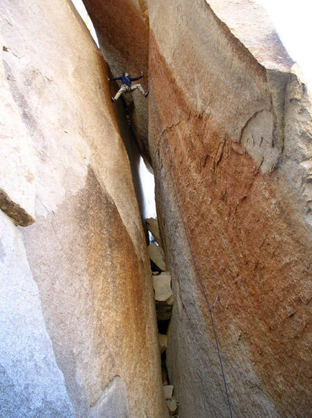 Holden flies up the variable chimney and stemming moves of this wild climb. Copyright 2003, by Randy V.